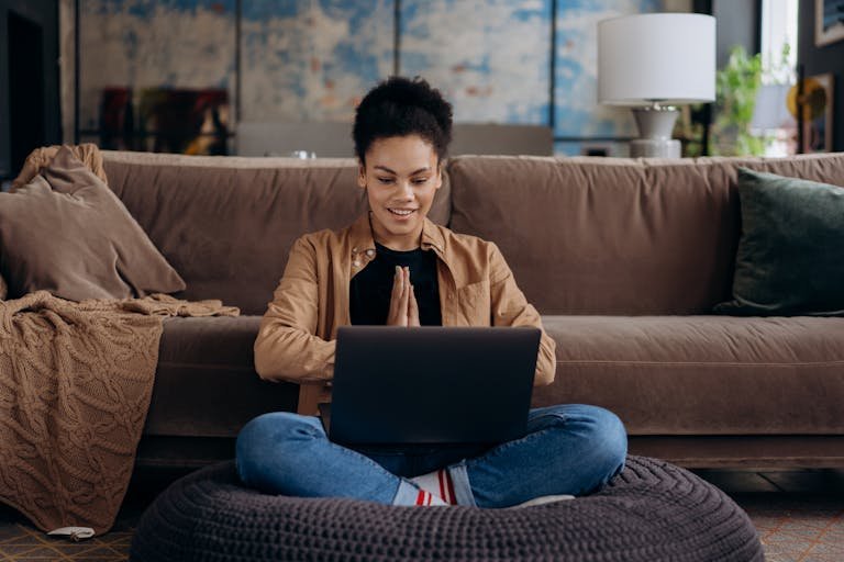 Young woman exploring AI side hustle ideas in 2025 using laptop — beginner-friendly work setup